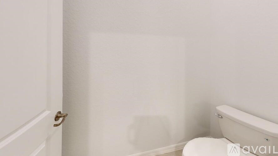 A white bathroom with a toilet and a bathtub.