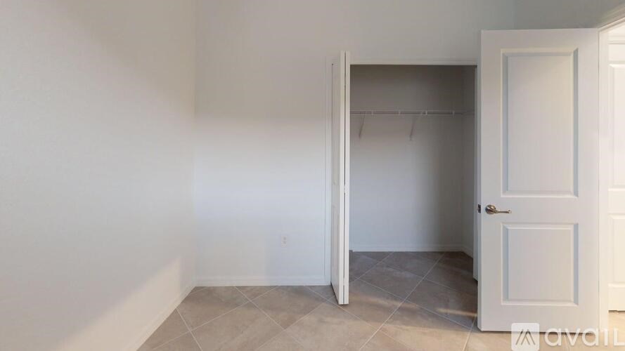 A room with a white door and a white wall.