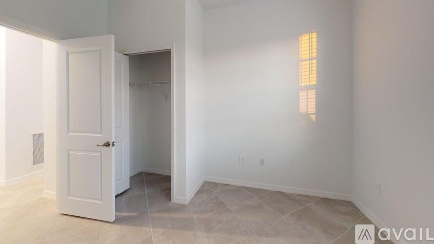 A room with a door and a wall light.