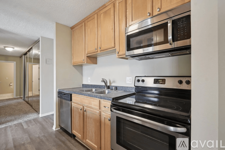 A kitchen with wooden cabinets and a black stove top oven.
