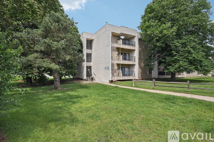 A building with the number 410 on it is surrounded by trees.