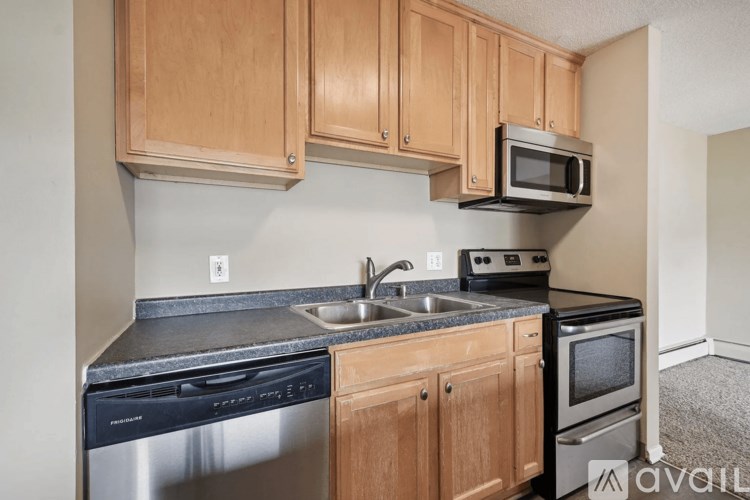 A kitchen with wooden cabinets and stainless steel appliances.