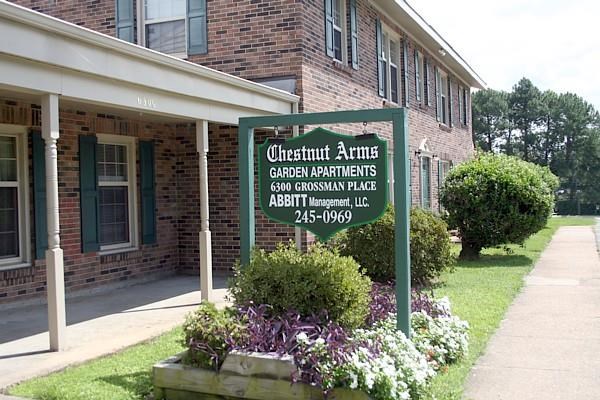 a green sign in front of a building