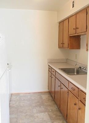 a kitchen with a sink and wooden cabinets