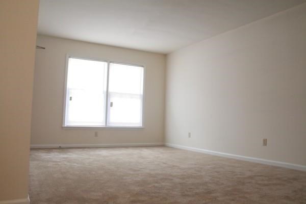 a empty living room with a window in it