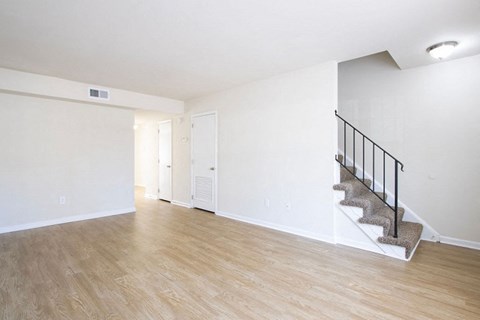 A room with a staircase and a door.