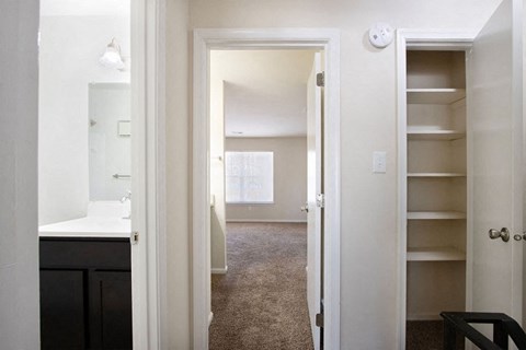 A white doorway leads to a room with a carpeted floor.