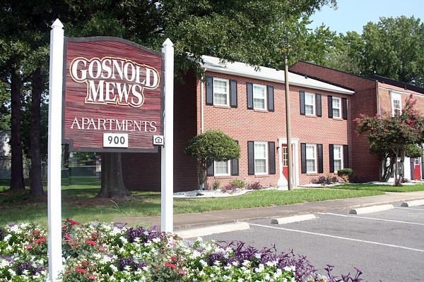 a sign in front of a mens apartments building