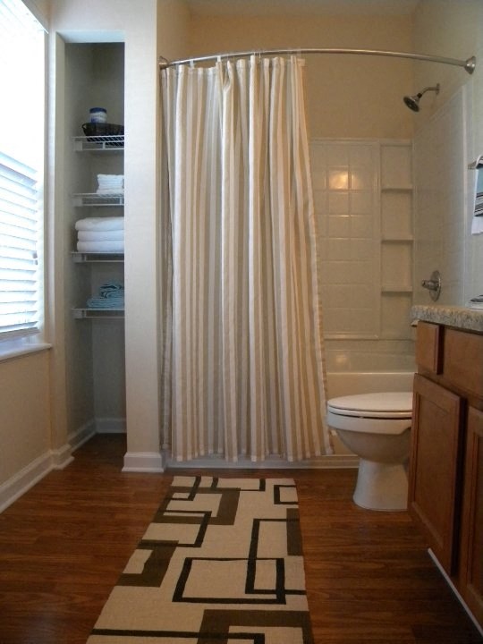 a bathroom with a toilet and a shower with a shower curtain