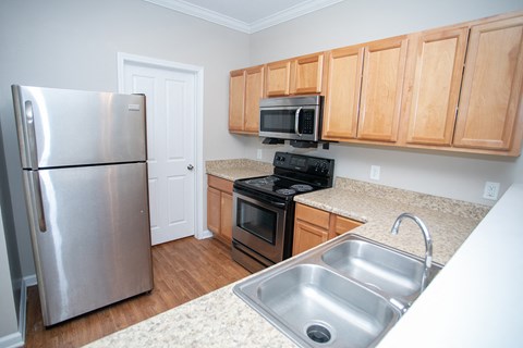 a kitchen with stainless steel appliances and wooden cabinets