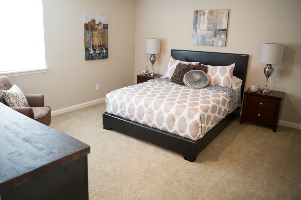 a bedroom with a bed and a couch and a window