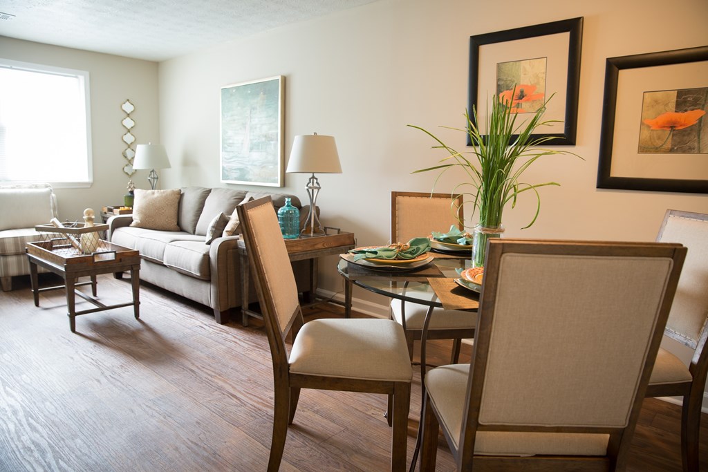 a living room with a dining room table and a couch