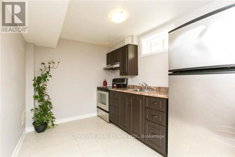 A kitchen with brown cabinets and a white countertop.