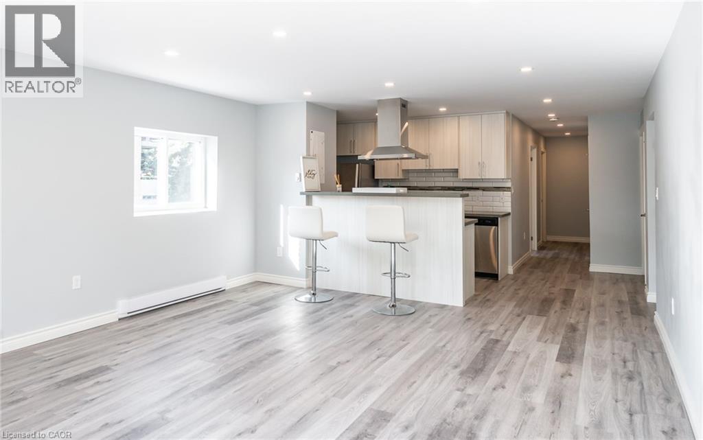 A modern kitchen with a bar stool in the middle.