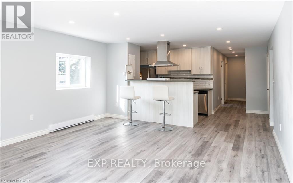 A modern kitchen with a bar stool in the middle.
