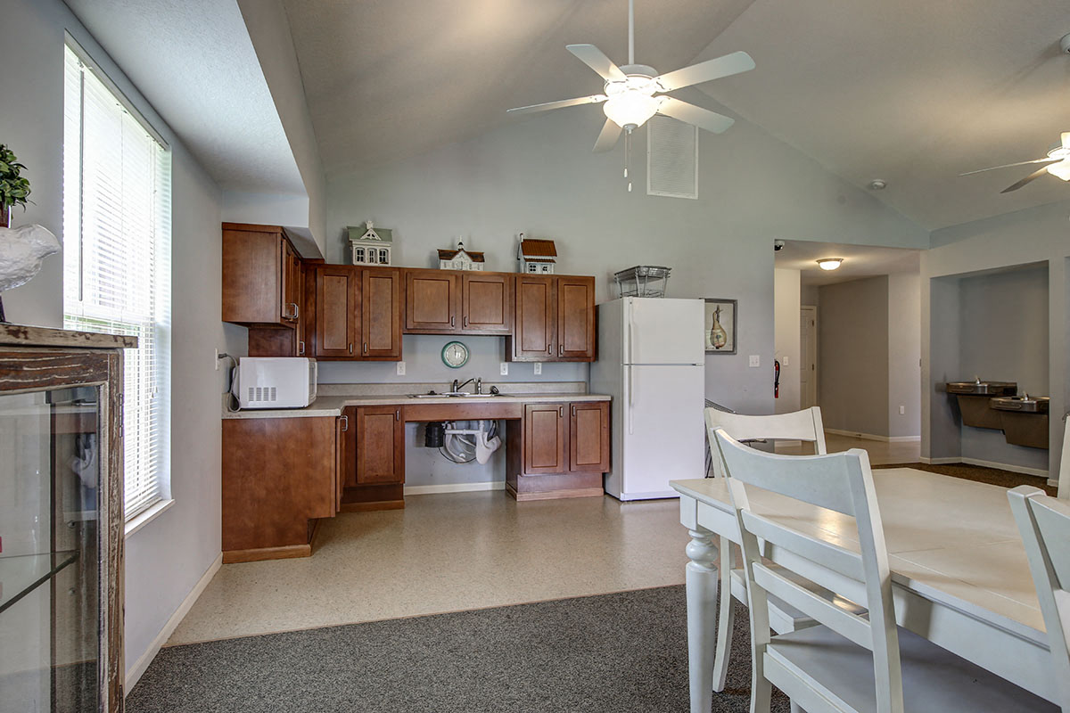 a kitchen with wooden cabinets and a white refrigerator