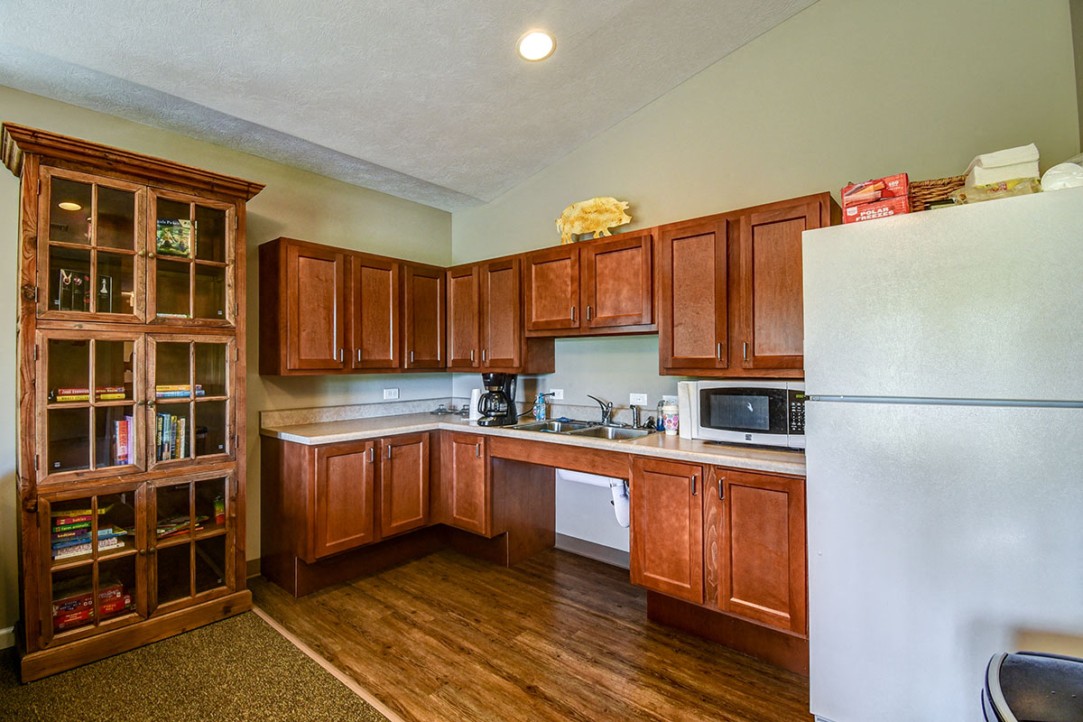 a kitchen with wooden cabinets and a white refrigerator