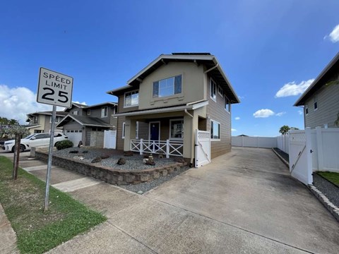 A house with a speed limit sign of 25 in front of it.