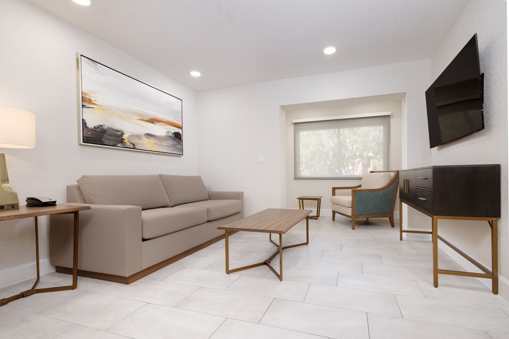 A living room with a couch, armchair, and coffee table.