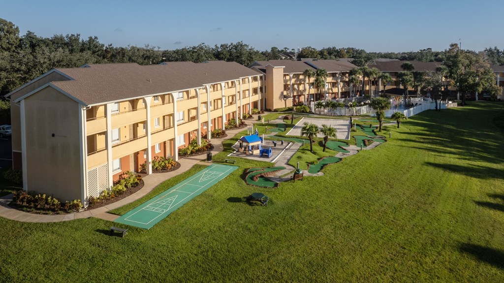 A large grassy area in front of apartment buildings.