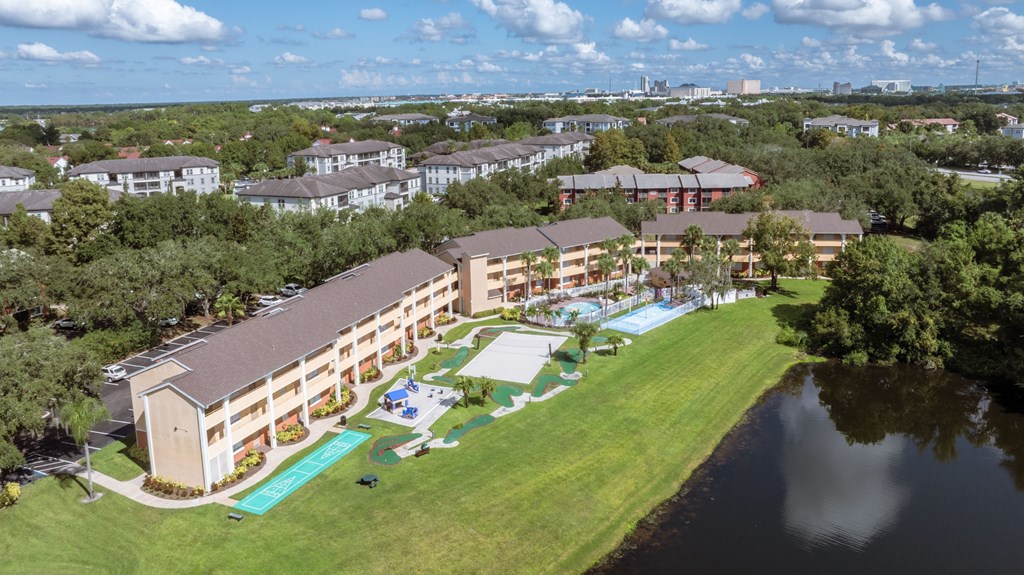 A large building with a pool in front of it.
