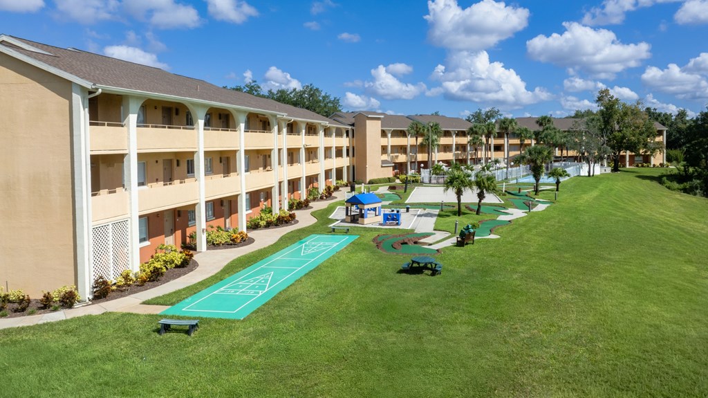 A green lawn in front of a building.