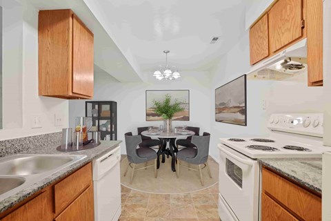 A kitchen with a table and chairs in the middle.