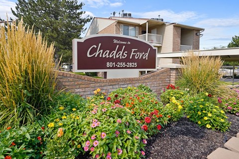 A sign that says "Welcome to Chadds Ford" is in front of a building.