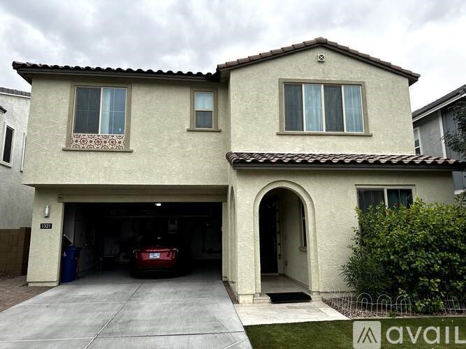 A house with a garage and a car inside.