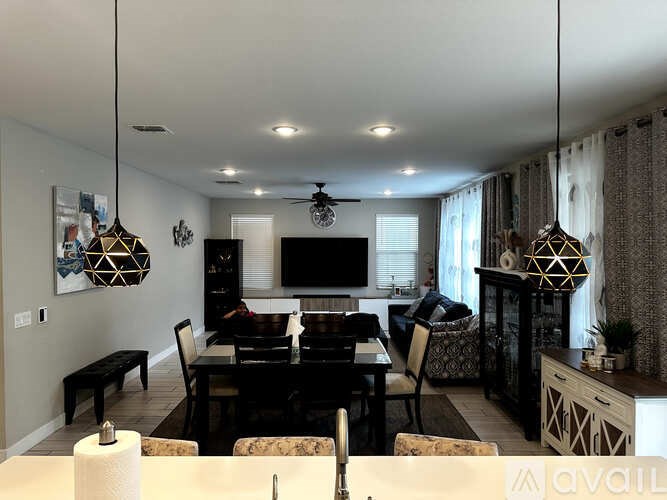 A modern dining room with a black table and chairs.