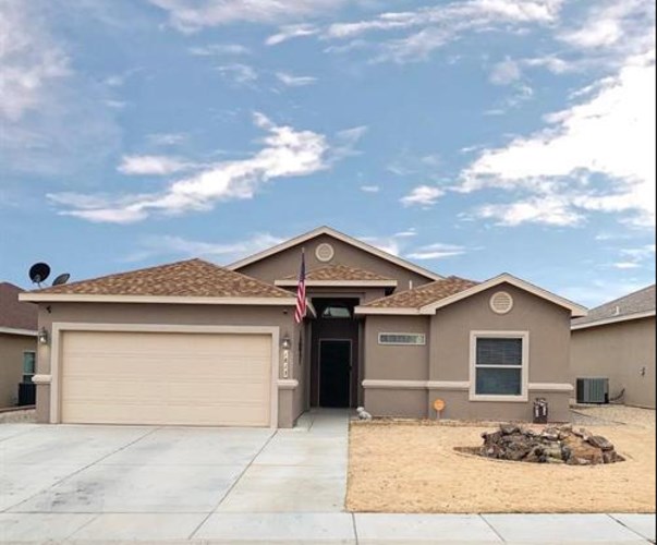 A house with a garage door and an American flag.