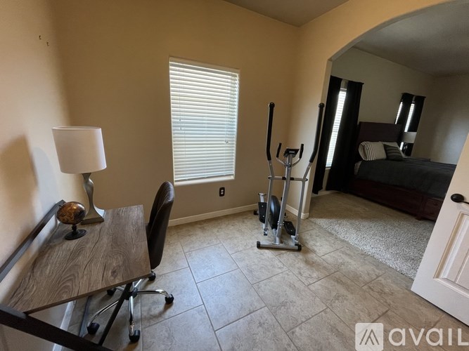 A room with a chair, a table, and a lamp.