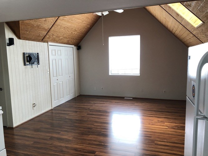A room with wooden floors and a window.