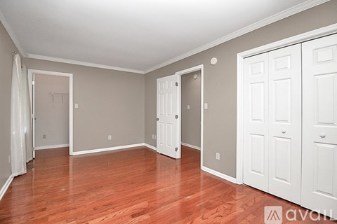 A room with wooden floors and white walls.