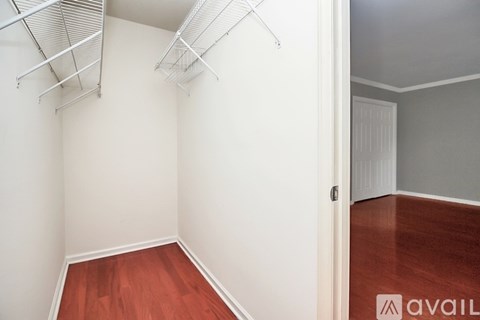 A room with a white wall and a wooden floor.