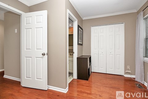 A room with a white door and a black speaker in it.