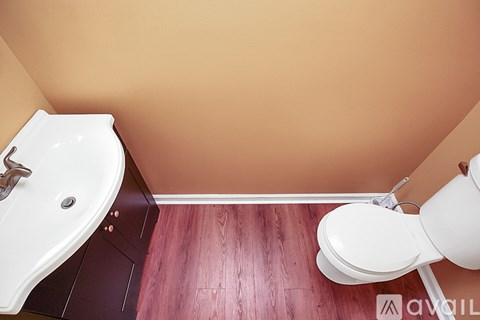A white toilet sits next to a sink in a bathroom.