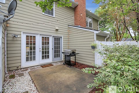 A house with a satellite dish on the left side and a white fence on the right side.