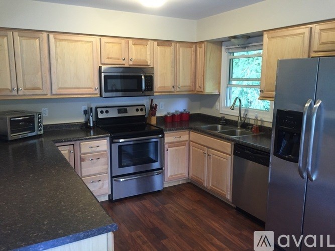 A kitchen with wooden cabinets and stainless steel appliances.
