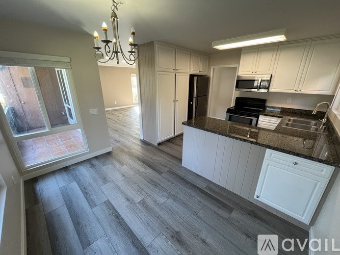 A kitchen with a refrigerator, stove, and oven.