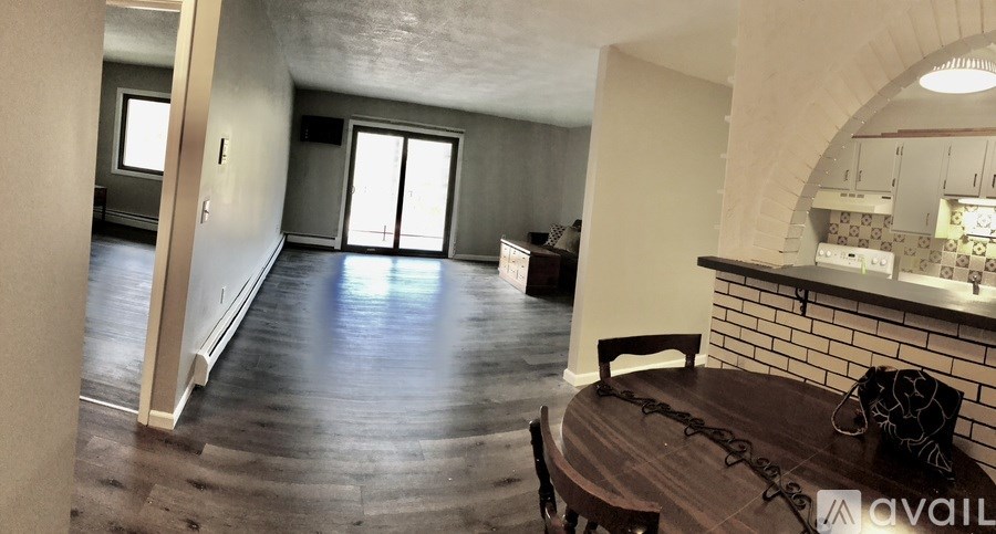 A dining room with a wooden table and chairs is available for rent.