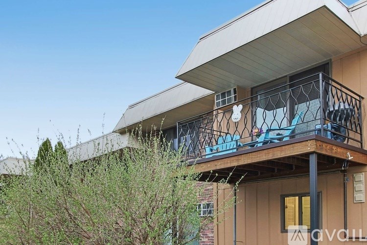 A balcony with a metal railing and a spider web decoration.