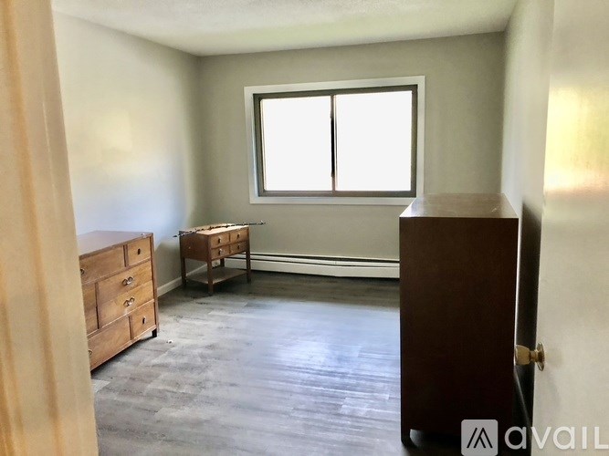 A room with a desk and a bed in it.