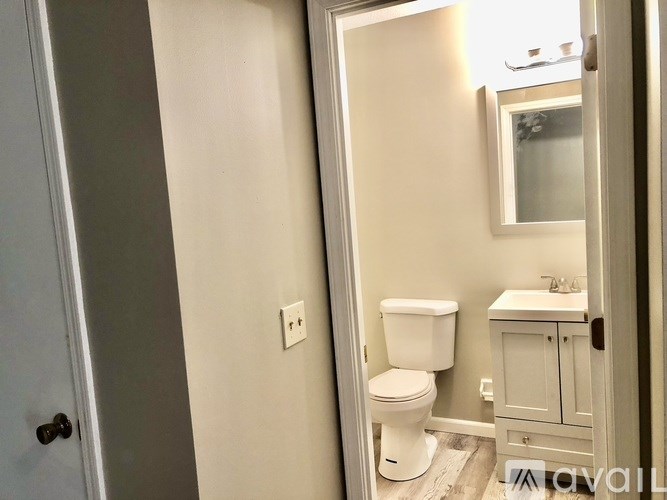 A white toilet and sink in a bathroom.