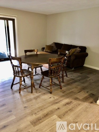 A dining room with a table and chairs.