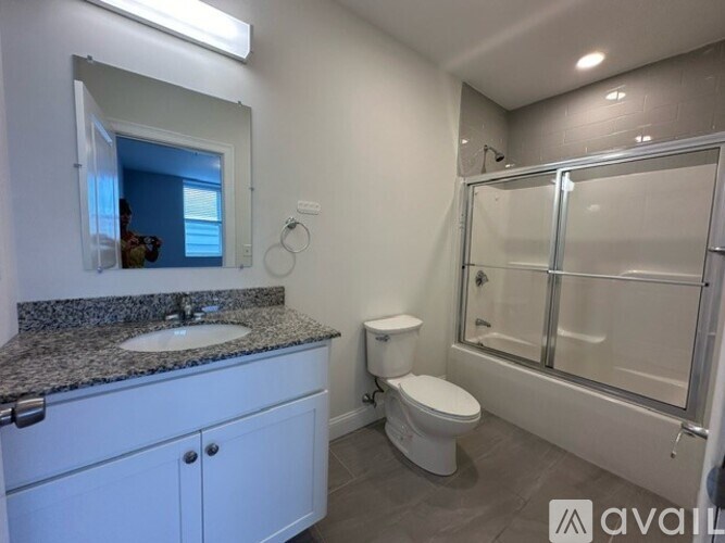 A bathroom with a sink, toilet, and shower.