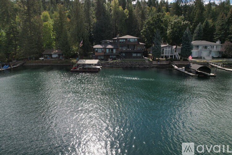 A house is situated on the waterfront with a dock and a boat.