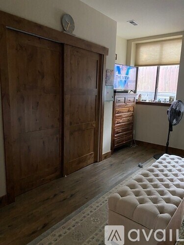 A room with a white couch and a wooden door.