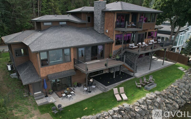 A large house with a stone wall and a patio.