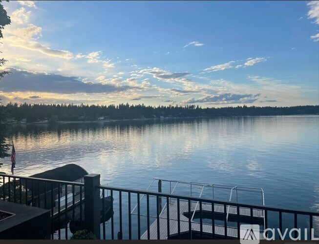 A serene lake view with a dock and a flag.